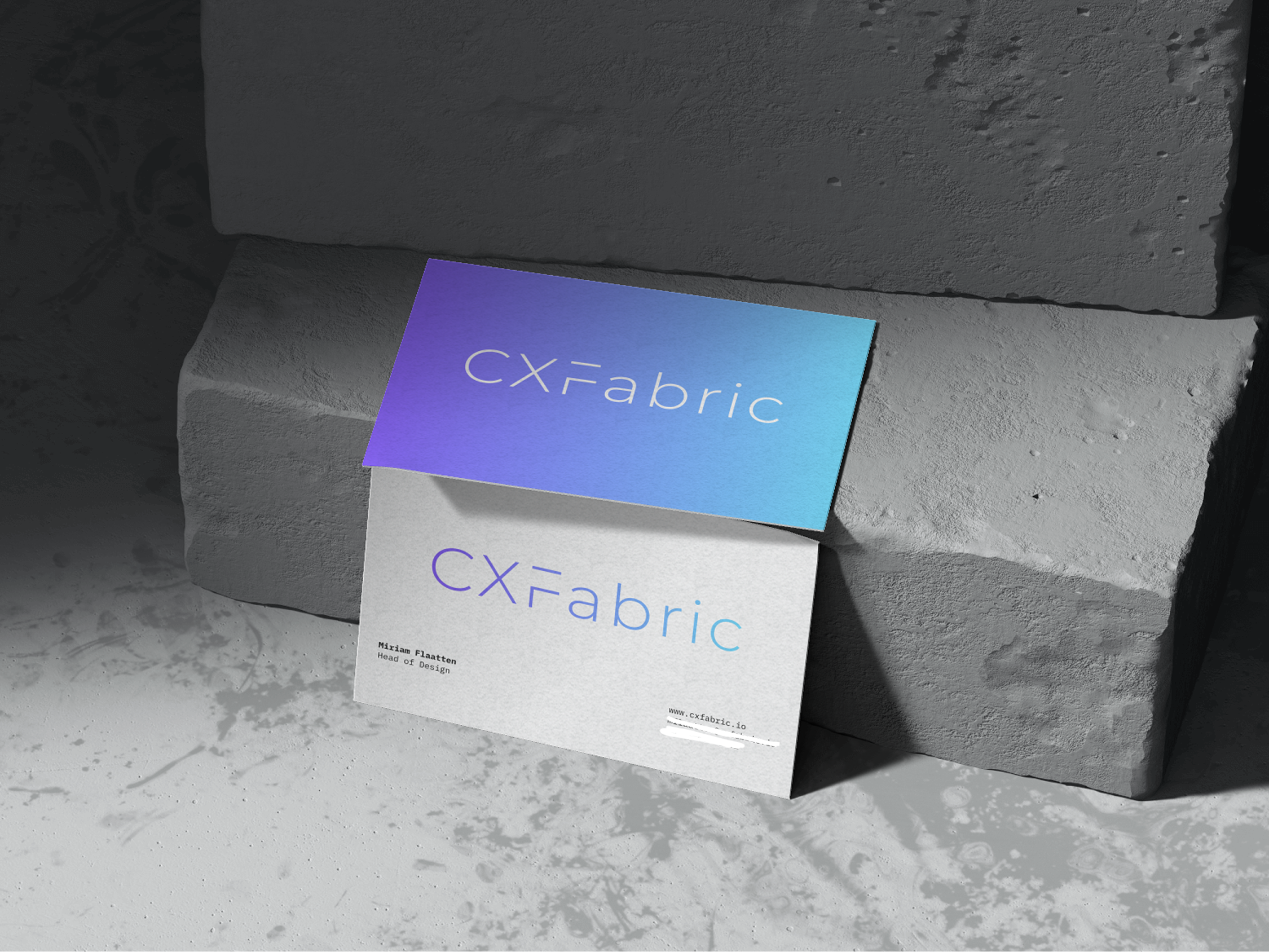 CXFabric business cards featuring the purple-to-blue gradient brand identity